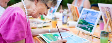 Side,View,Of,A,Happy,Senior,Woman,Smiling,While,Drawing