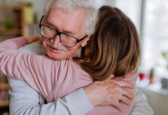 Rear,View,Of,Adult,Daughter,Hugging,Her,Senior,Father,When